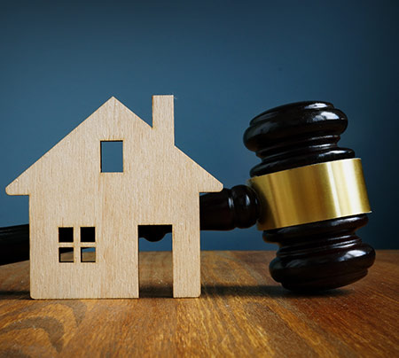 Gavel next to a small model house