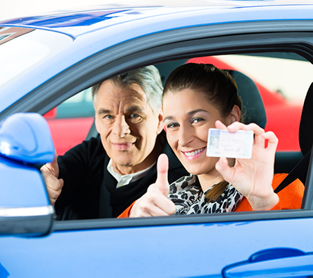 Two car passengers displaying a driver's license