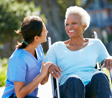 Woman helping older woman