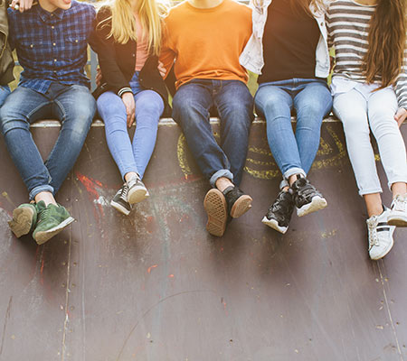 Teenagers sitting on a wall