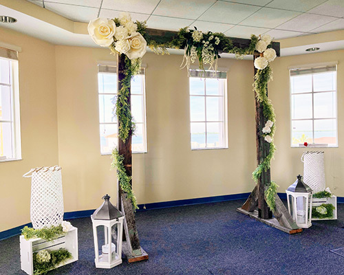 Wedding Ceremonial Room with wooden arch with floral decorations